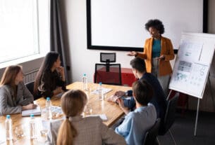 Pessoas reunidas numa sala aprendendo sobre educação corporativa